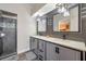 Modern bathroom featuring double vanity sinks, a tiled shower, and contemporary fixtures at 15442 Arvin Dr, Brooksville, FL 34604