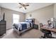 Neutral bedroom with a bed, desk, and ceiling fan at 15442 Arvin Dr, Brooksville, FL 34604