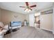 Neutral bedroom with a ceiling fan, crib, and doorway leading to another room at 15442 Arvin Dr, Brooksville, FL 34604