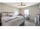 Neutral bedroom with a bed, desk, and ceiling fan at 15442 Arvin Dr, Brooksville, FL 34604