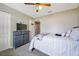 Neutral bedroom with a bed, dresser, and ceiling fan at 15442 Arvin Dr, Brooksville, FL 34604