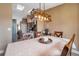 Bright dining area showcasing a stylish light fixture, table setting, and views of the adjacent kitchen at 15442 Arvin Dr, Brooksville, FL 34604