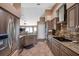 Well-lit kitchen with stainless steel appliances, granite counters, and stone backsplash at 15442 Arvin Dr, Brooksville, FL 34604
