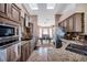 Open kitchen featuring granite counters, stainless appliances, and a view into the dining area at 15442 Arvin Dr, Brooksville, FL 34604