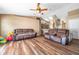Spacious living room with hardwood floors, neutral paint, and access to the kitchen at 15442 Arvin Dr, Brooksville, FL 34604