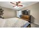 Comfortable bedroom featuring a ceiling fan, carpet flooring, and a large window at 15442 Arvin Dr, Brooksville, FL 34604