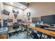An organized office space featuring dual monitors, a comfortable chair, and woodgrain desks at 15442 Arvin Dr, Brooksville, FL 34604