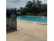 A view of the community swimming pool with poolside signage and fencing at 15442 Arvin Dr, Brooksville, FL 34604