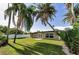 Home with an expansive fenced-in backyard, lush lawn, and mature trees, perfect for outdoor enjoyment at 1800 Mapleleaf Blvd, Oldsmar, FL 34677
