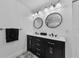 Modern bathroom features dual sinks, contemporary mirrors and black hardware at 1800 Mapleleaf Blvd, Oldsmar, FL 34677