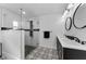 Modern bathroom with glass enclosed shower, patterned tile floor and dual sinks at 1800 Mapleleaf Blvd, Oldsmar, FL 34677