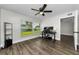 Bedroom with a ceiling fan and a large window with views of the green yard at 1800 Mapleleaf Blvd, Oldsmar, FL 34677