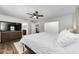 Spacious bedroom with wood floors, ceiling fan, and access to en suite bathroom at 1800 Mapleleaf Blvd, Oldsmar, FL 34677
