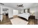 Light filled bedroom with wood floors, neutral walls, ceiling fan and decorative area rug at 1800 Mapleleaf Blvd, Oldsmar, FL 34677