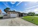 Single-story home with attached garage, wide driveway, and well-maintained lawn, offering comfort and convenience at 1800 Mapleleaf Blvd, Oldsmar, FL 34677