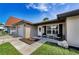 Single-story home with an inviting entrance, manicured lawn, and decorative touches for enhanced curb appeal at 1800 Mapleleaf Blvd, Oldsmar, FL 34677