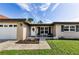 Inviting front porch with seating, a white front door, and a view of the landscaped front yard at 1800 Mapleleaf Blvd, Oldsmar, FL 34677