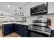 Modern kitchen with stainless steel appliances, subway tile backsplash, and blue cabinets at 1800 Mapleleaf Blvd, Oldsmar, FL 34677