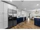 Bright kitchen with stainless steel appliances, a combination of blue and white cabinets, and wood-look floors at 1800 Mapleleaf Blvd, Oldsmar, FL 34677