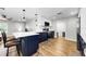 Modern kitchen featuring two-tone cabinetry, stainless steel appliances, and a spacious island with seating at 1800 Mapleleaf Blvd, Oldsmar, FL 34677