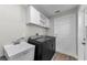 Efficient laundry room with ample cabinet space, utility sink and appliances at 1800 Mapleleaf Blvd, Oldsmar, FL 34677