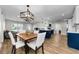 Open layout with living, dining, and kitchen areas, showcasing wood floors and modern finishes at 1800 Mapleleaf Blvd, Oldsmar, FL 34677