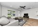 Cozy living room featuring neutral tones, wood-look floors, and a ceiling fan at 1800 Mapleleaf Blvd, Oldsmar, FL 34677