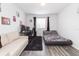 Cozy bedroom with natural light, a comfortable couch, and a modern black rug at 18136 Nassau Point Dr, Tampa, FL 33647