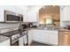 Modern kitchen with granite countertops, stainless steel appliances, and white cabinets at 18136 Nassau Point Dr, Tampa, FL 33647