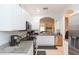 Bright kitchen with stainless steel appliances, granite countertops, and an open layout to the living area at 18136 Nassau Point Dr, Tampa, FL 33647