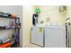 Laundry room features a washer, dryer, shelving, and storage for supplies at 18136 Nassau Point Dr, Tampa, FL 33647