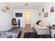 Living room with a cozy couch, mounted TV, and decor; hardwood-style flooring at 18136 Nassau Point Dr, Tampa, FL 33647