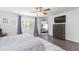 Spacious bedroom with a ceiling fan, ensuite bath, and a large window providing ample natural light at 18136 Nassau Point Dr, Tampa, FL 33647