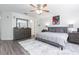 Bright, spacious bedroom with ensuite bath, a ceiling fan, and a large window providing ample natural light at 18136 Nassau Point Dr, Tampa, FL 33647