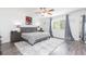 Spacious bedroom with a ceiling fan, ensuite bath, and a large window providing ample natural light at 18136 Nassau Point Dr, Tampa, FL 33647