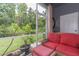 Cozy screened-in patio featuring comfortable seating and lush greenery at 18136 Nassau Point Dr, Tampa, FL 33647