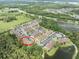 Aerial view of a neighborhood featuring townhomes, parking, and natural landscaping around lakes at 2349 Willimette Dr, Wesley Chapel, FL 33543