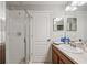 Bathroom featuring glass-enclosed shower, white door and vanity with tan countertop at 2349 Willimette Dr, Wesley Chapel, FL 33543