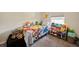 Bright bedroom featuring a window, carpeted floor and whimsical Pokemon themed decor at 2349 Willimette Dr, Wesley Chapel, FL 33543