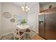 Bright dining area with a round table, white chairs, and stainless steel refrigerator at 2349 Willimette Dr, Wesley Chapel, FL 33543