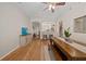Comfortable dining area with wood floors, modern table, and seamless transition to the kitchen at 2349 Willimette Dr, Wesley Chapel, FL 33543