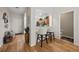 Inviting entryway with wood floors, stylish decor, and an open view into the well-equipped kitchen at 2349 Willimette Dr, Wesley Chapel, FL 33543