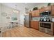 Charming eat-in kitchen with stainless steel appliances, wood cabinets, and a cozy dining area at 2349 Willimette Dr, Wesley Chapel, FL 33543