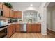 Bright kitchen featuring stainless steel appliances, modern fixtures, and an open view into the adjacent room at 2349 Willimette Dr, Wesley Chapel, FL 33543