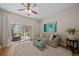 Bright living room featuring a plush sofa, stylish coffee table, and serene views of the greenery at 2349 Willimette Dr, Wesley Chapel, FL 33543