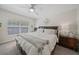 Relaxing bedroom with large window, side table, and soft lighting creating a serene and comfortable space at 2349 Willimette Dr, Wesley Chapel, FL 33543