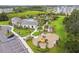 An aerial view of a community pool, playground, clubhouse, and well-maintained landscaping at 2518 Chapel Oak Bnd, Wesley Chapel, FL 33543