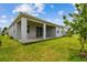 Backyard with a covered patio, lush green lawn, and side yard landscaping at 2518 Chapel Oak Bnd, Wesley Chapel, FL 33543