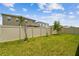 Green backyard with a vinyl fence separating neighbors homes at 2518 Chapel Oak Bnd, Wesley Chapel, FL 33543