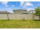 Fenced backyard with green lawn and young trees at 2518 Chapel Oak Bnd, Wesley Chapel, FL 33543